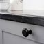 LAND vintage round zamak furniture knob in brushed gold, antique brass, pewter or matt black for rustic and industrial cabinets.