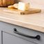 FIRM zamak handle with bold industrial design mounted on a contemporary cabinet drawer front.
