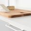 RIM zamak handle with minimalist curved design mounted on a contemporary cabinet drawer front.
