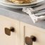 QUART BIG quare zamak knob with rustic vintage design mounted on a classic cabinet door.
