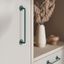 MILANO tubular zamak handle with a sleek minimalist design, mounted vertically on a contemporary cabinet door.