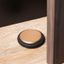 LOW aluminium door stopper in Brushed Brass or Lava Grey with a flat circular design.