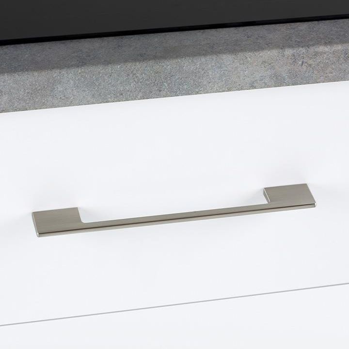 DINO slim zamak handle with a gently curved profile mounted horizontally on a contemporary cabinet drawer.