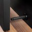 ARPA WALL aluminium wall-mounted door stopper in Stainless Steel Look, Brushed Black, Brushed Dark Brass or Rustic Brass.