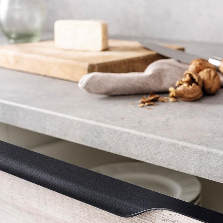 VECTOR Aluminium-Profilgriff mit ergonomischem, abgerundetem Design an einer modernen Küchenschranktür montiert.