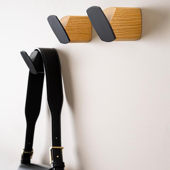 MEGG wood and zamak wall hook in Oak + Lava Black, Walnut + Lava Black or Matt Black Ash.