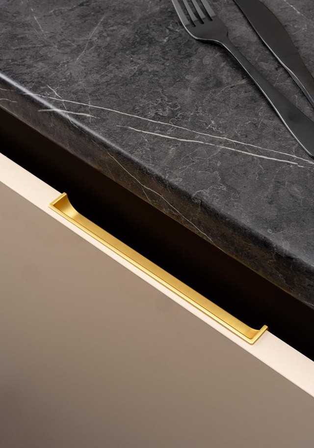HIDE recessed zamak handle with minimalist integrated design mounted on a contemporary cabinet drawer front.